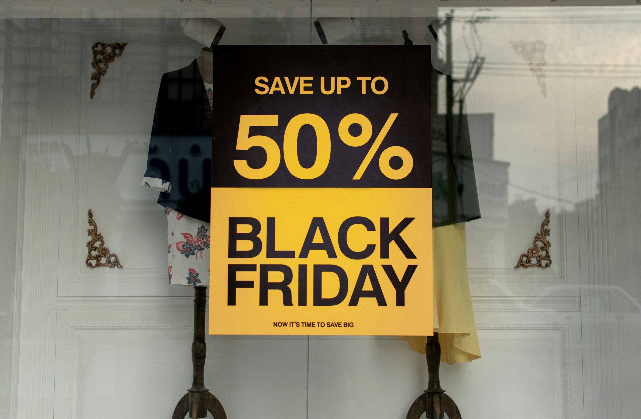Black Friday shop window sign advertising up to 50 percent off, highlighting retail promotions and seasonal discounts.